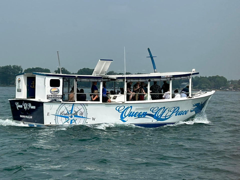 Queen new look a small boat in a large body of water